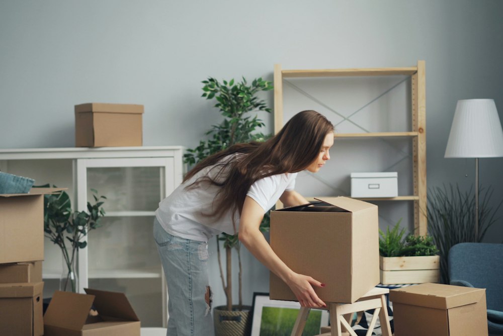 Packing belongings into moving boxes